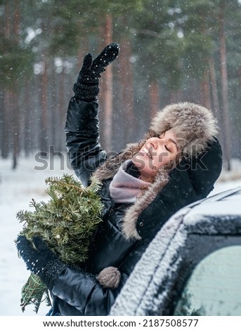 beautiful young woman enjoying a winter day in a forest