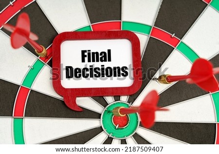 Business concept. On the darts are darts and a sign with the inscription - Final Decisions