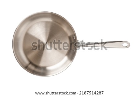 Empty stainless steel skillet isolated on a white background. New frying pan of 18 10 chrome nickel steel cutout. Modern inox cookware. Metal frypan for food frying, searing, and browning. Top view. Royalty-Free Stock Photo #2187514287