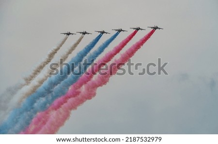 Russian Air Force planes paint the colors of the Russian flag in the sky on St. Petersburg during the celebration of the Day of the Navy Royalty-Free Stock Photo #2187532979