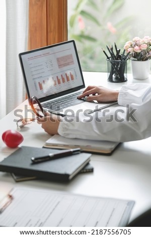 Female doctor working on laptop computer, analyzing and report treatment effect at office, Medical healthcare and doctor service concept.