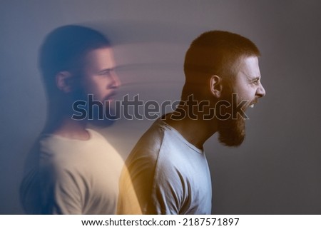 Side view portrait of two-faced man in calm serious and angry screaming expression. Different emotion inside and outside mood. Internally suffering, dissociative identity disorder. Double exposure. Royalty-Free Stock Photo #2187571897