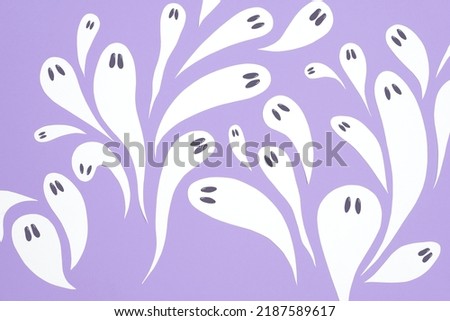 Halloween design, group of cute white ghosts flying on lilac background, pastel color trendy composition.