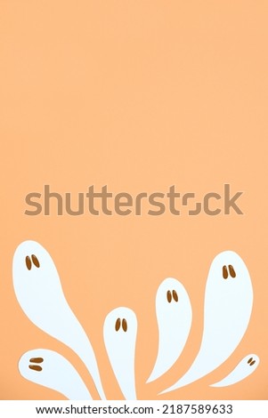 Halloween design, group of cute white ghosts flying on pastel orange color background, trendy composition with copy space.