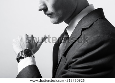Businessman checking the time on his wrist watch