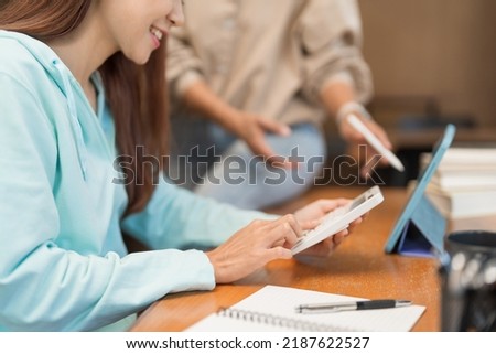 Education concept, Teenage girl use calculator to doing math quiz while tutor explaining lesson. Royalty-Free Stock Photo #2187622527