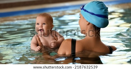 Cute little baby with mother in pool