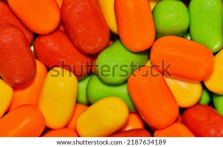 Colorful tic tac candy background, vibrant multi color candies, macro full frame image.