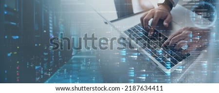 Computer engineer working on laptop computer with server room, data center, big data storage as backgrounds, digital technology, database, IT support, telecommunication, internet network technology Royalty-Free Stock Photo #2187634411