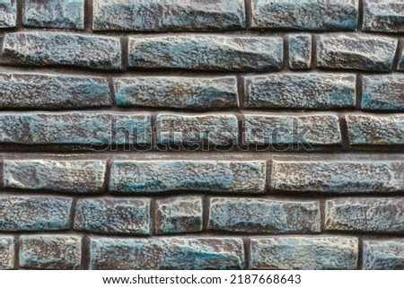 Modern brick wall concrete or stone seamless textured. Empty background of turquoise brick wall texture. Grid uneven interior rock. Home decor design backdrop.