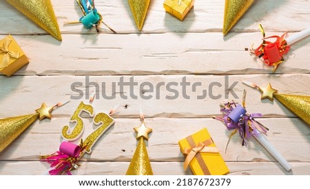 Beautiful colorful card on the background of white boards happy birthday in golden hues copy space. Beautiful ornaments and decorations of gold color festive background. Happy birthday number 57