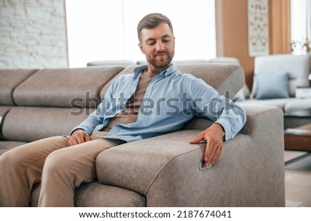 Sitting and enjoying. Customer visiting the sofa and bed store. Looking for update.