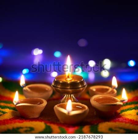 Happy Diwali, Oil lamps lit on colorful rangoli with copy space Royalty-Free Stock Photo #2187678293