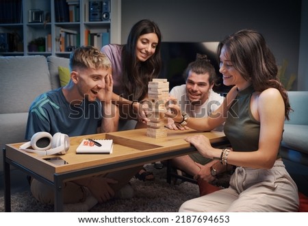 Group of friends playing table games at home, they are playing together Royalty-Free Stock Photo #2187694653