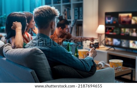 Friends choosing a movie to watch together at home, video on demand concept Royalty-Free Stock Photo #2187694655