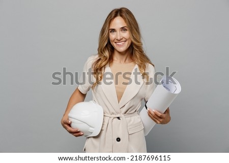Young architect engineer designer employee white woman 30s she wear pastel clothes hold blueprints hardhat isolated on plain light grey background studio portrait. People work on architecture project Royalty-Free Stock Photo #2187696115