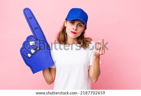 young pretty woman  making capice or money gesture, telling you to pay. number one hand fan concept