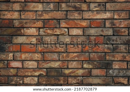 Wall made of old red bricks of different shades. Texture, background for design.