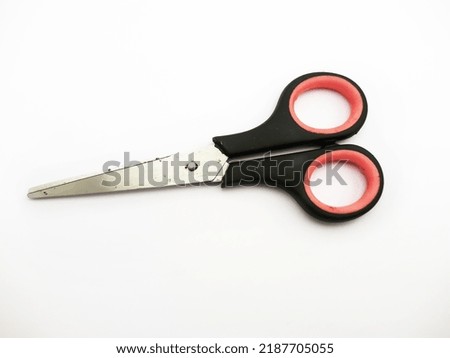 A black and pink hilt scissors, on a white background
