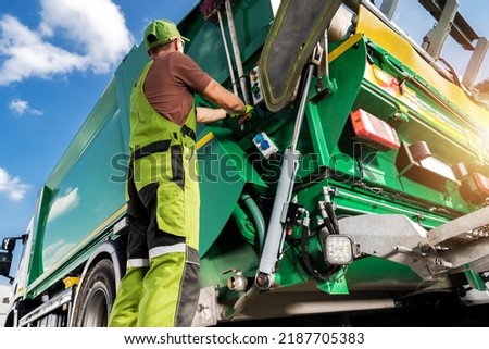 Modern Garbage Truck and Caucasian Waste Collector Worker. Waste Sorting and Management Theme. Royalty-Free Stock Photo #2187705383