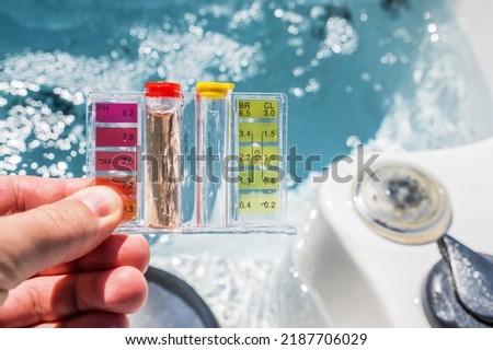 Hot Tub Water Quality Check by Using Chemical Testing Kit. pH, Chlorine and Bromine Concentration. Garden SPA Water Maintenance. Royalty-Free Stock Photo #2187706029