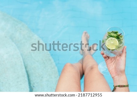 Irreconcilable woman relaxing in a swimming pool.