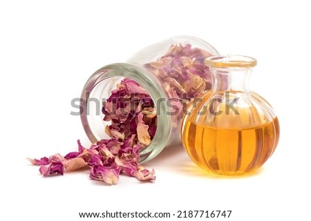 Damask rose flowers and oil isolated on white background.