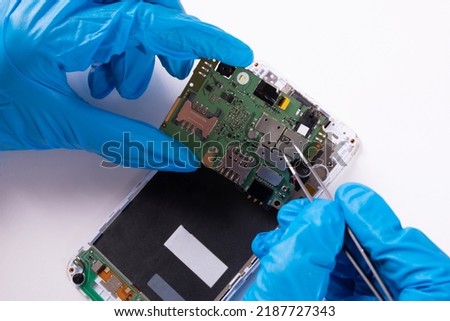 The process of repairing a mobile phone on a white background
