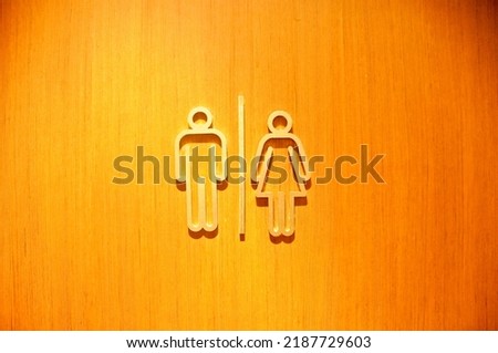 Man and woman sign symbols of toilet wooden doorin a pub
