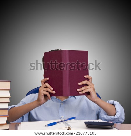 child at the table with books from school 