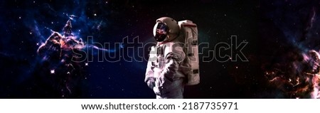 Astronaut in space in the solar system Earth. Blue light on background. Elements of this image furnished by NASA