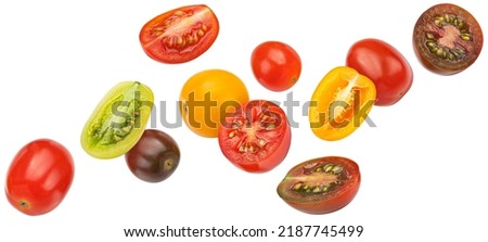 Falling colorful cherry tomatoes isolated on white background Royalty-Free Stock Photo #2187745499
