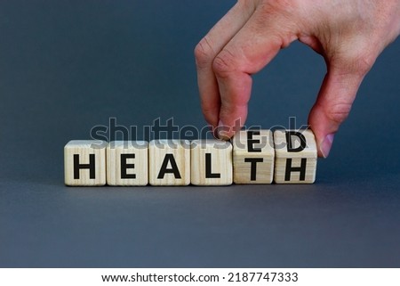 Healed health symbol. Doctor turns wooden cubes and changes concept words Healed to Health. Beautiful grey background. Medical healed health concept. Copy space. Royalty-Free Stock Photo #2187747333