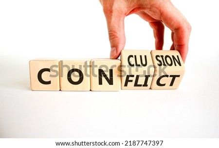 Conflict or conclusion symbol. Businessman turns wooden cubes and changes the word 'conflict' to 'conclusion'. Beautiful white background, copy space. Business, conflict or conclusion concept. Royalty-Free Stock Photo #2187747397