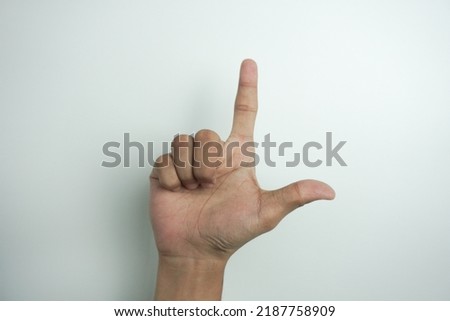 Alphabet - letter L spelling by man's hand in American Sign Language (ASL) on white background