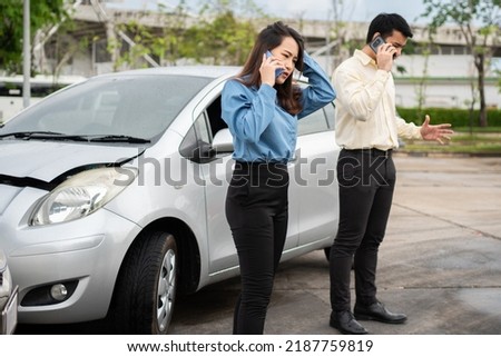 Two drivers call insurance after a car accident before taking pictures and sending insurance. Online car accident insurance claim idea after submitting photos and evidence to an insurance company.