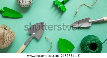 Frame from gardening tools and rope.House plant care concept.Photography from above,large banner.