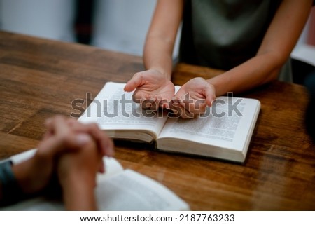 Close-up of a Christian family holding hands and praying. Comforting and Praying Together Christian Concepts and Bible Study to God