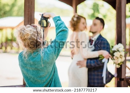 Wedding photographer photographing a couple in nature
