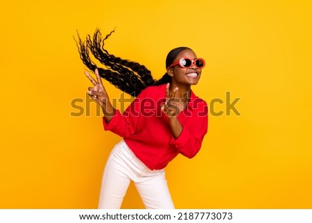 Photo of young pretty girl have fun show fingers peace v-symbol trip isolated over yellow color background