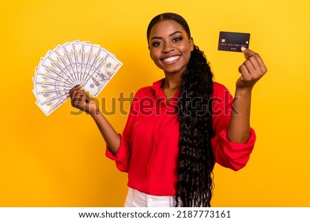 Photo of young pretty girl rich income profit credit card rich investment isolated over yellow color background