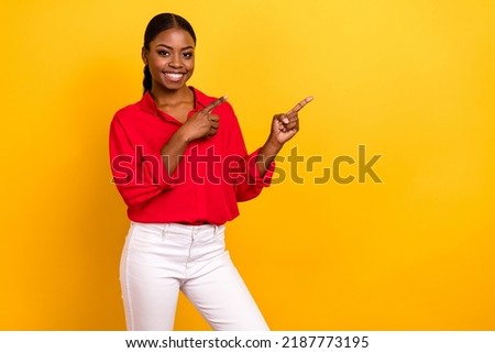 Photo of young pretty lady promoter indicate fingers empty space select direct banner isolated over yellow color background Royalty-Free Stock Photo #2187773195