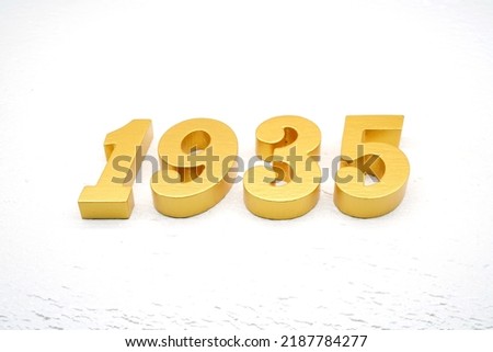   Number 1935 is made of gold painted teak, 1 cm thick, laid on a white painted aerated brick floor.                                