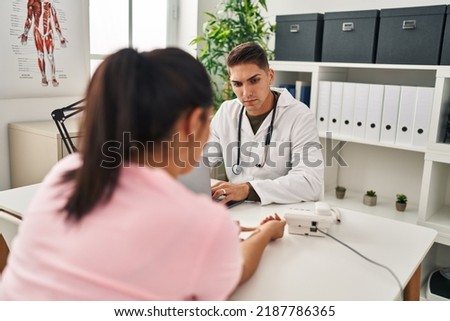 Man and woman doctor and patient having medical consultation at clinic