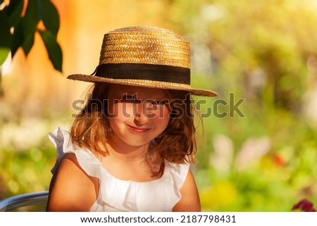 outdoor portrait of cute little girl in straw hat