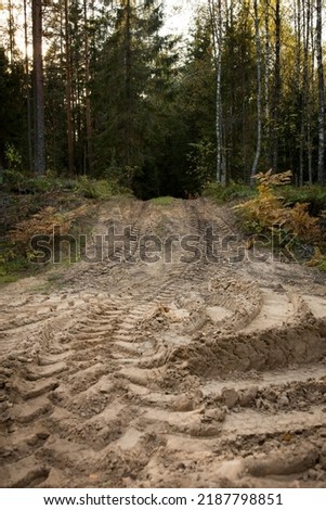 Wheel trail on sandy ground from large transport, tractor, sandy road