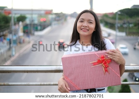 Happy young girl with gift box.