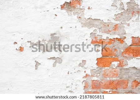 An old rough brick wall with peeling plaster. Abstract web banner. Space for copying.