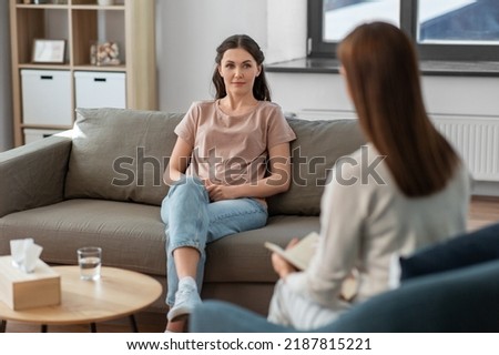 psychology, mental health and people concept - young woman patient and woman psychologist at psychotherapy session Royalty-Free Stock Photo #2187815221