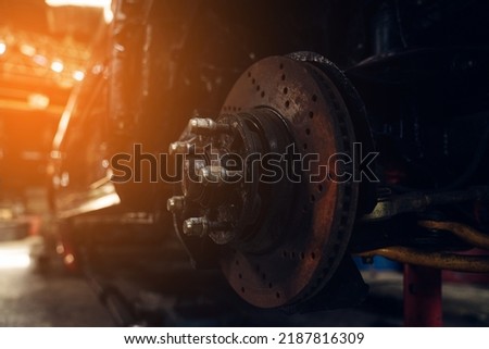 Closeup of Car in garage of auto repair service shop with special repairing equipment